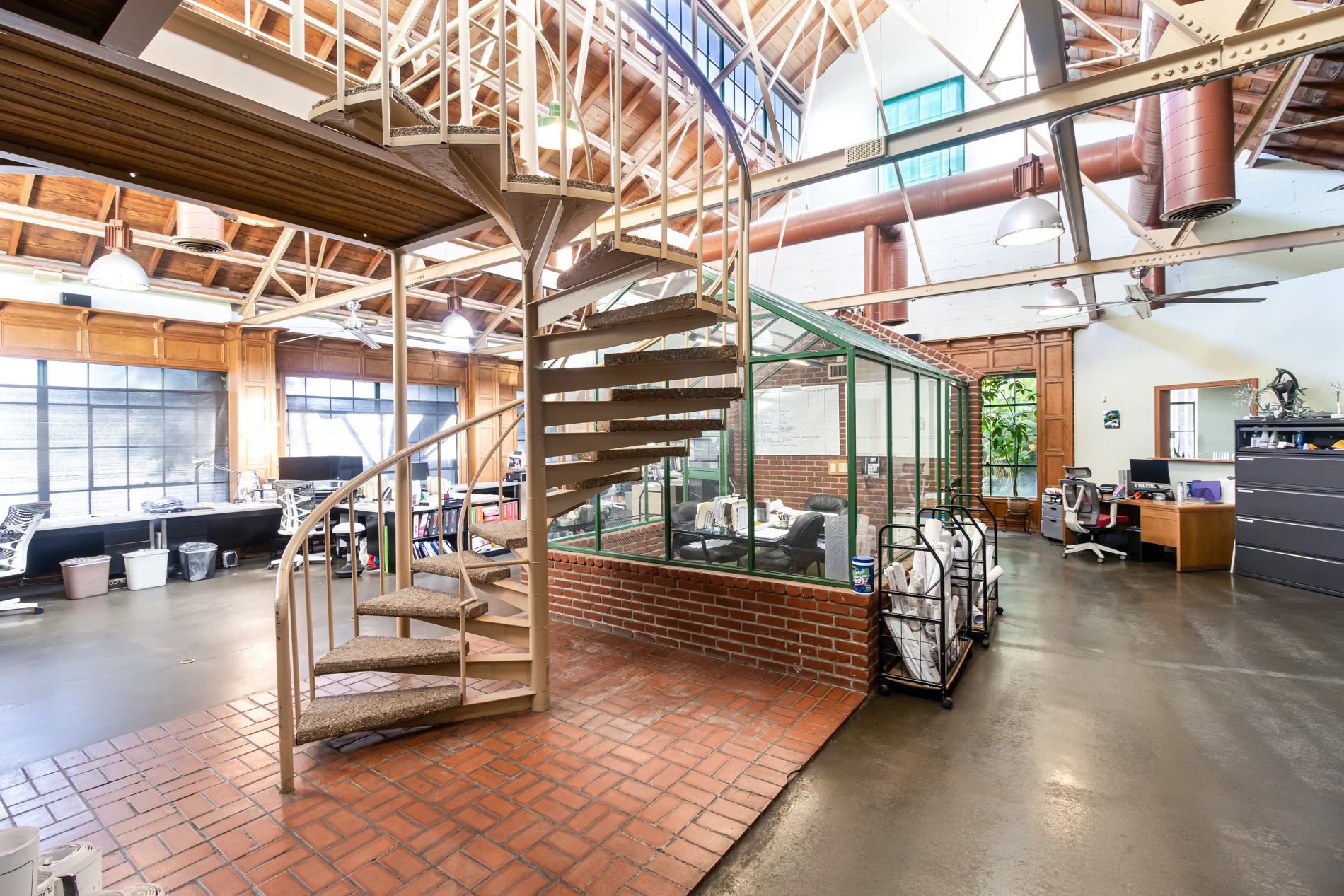The Grand Atrium ballroom as it exists today — soaring timber ceilings, steel beams, and expansive windows in an empty historic hall